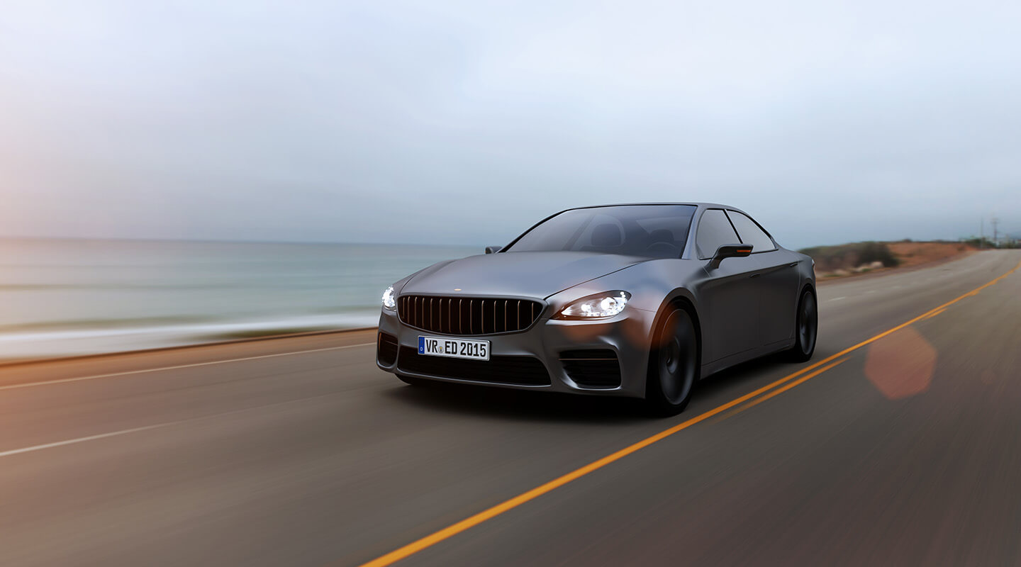 Car driving on a road by the sea at the Tire Pirates in Calgary, AB