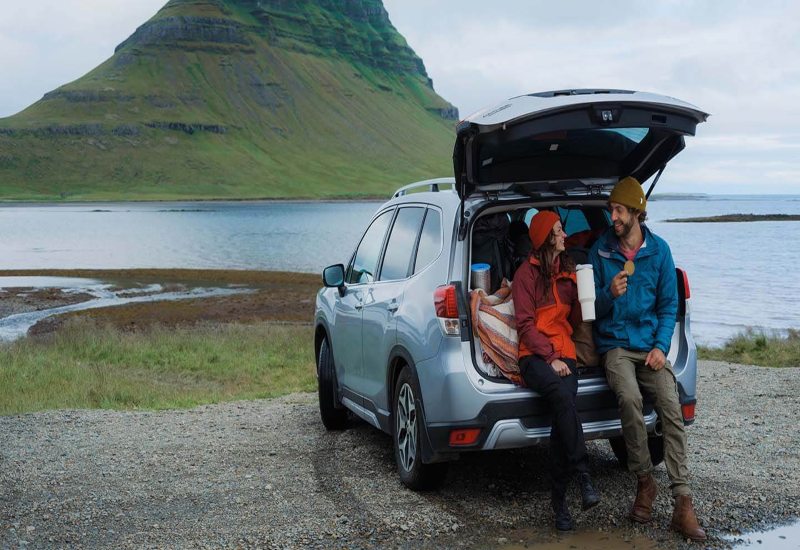 A woman and a man resting during a road trip in the garage at the Tire Pirates in Calgary, AB.