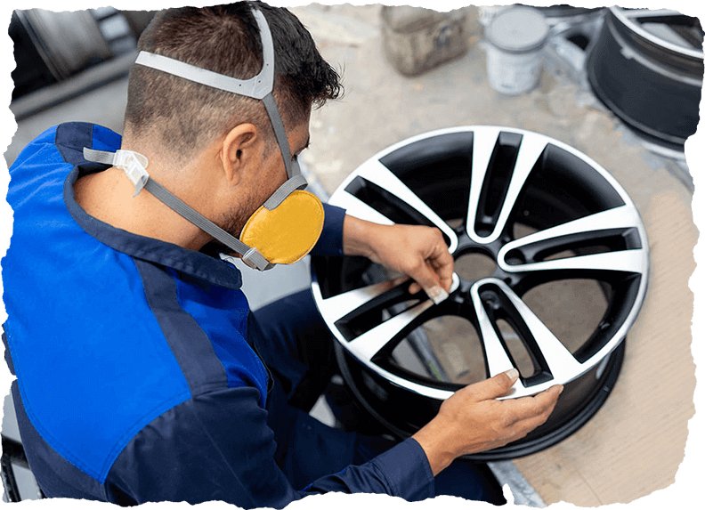 A Worker Sanding an Alloy Wheel at a Car Part Factory in Calgary, AB