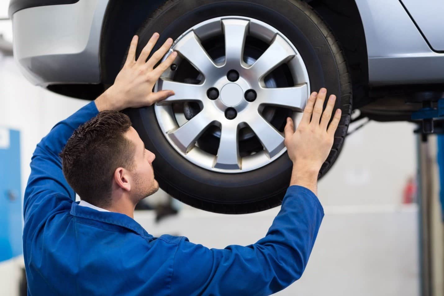 A man changing new alloy wheels car in Calgary, AB