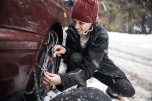 woman checking chains on tires