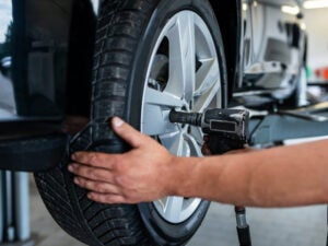 A man changing the new tire 