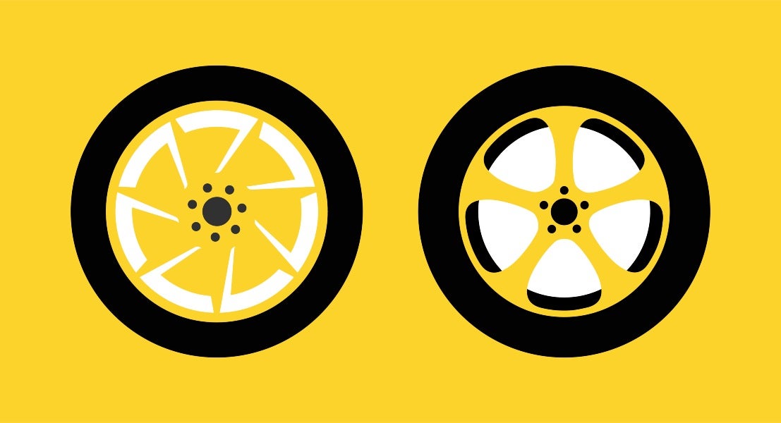 A pair of yellow and black wheels set on a bright yellow backdrop in Foothills & Chinook, Calgary.