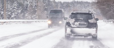 cars driving in snow with snow tires